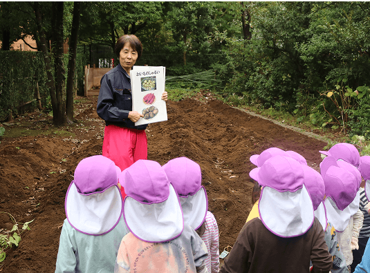 子供たちが森で活動内容を聞いている様子